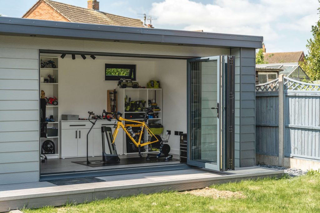 Inside of garden gym with doors open showing smart bike trainer