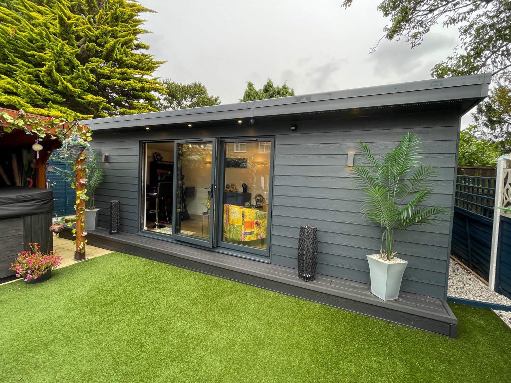 Garden entertaining room with grey cladding and grey bifold doors