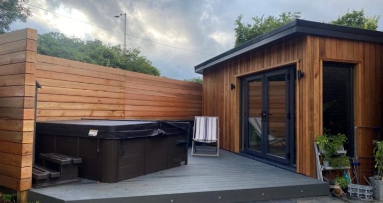 Garden gym with a hot tub on outside decking area