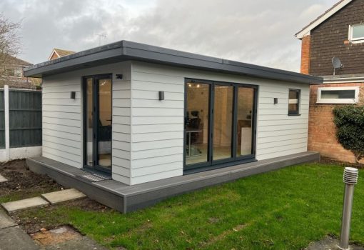 Side angle of garden office with white cladding
