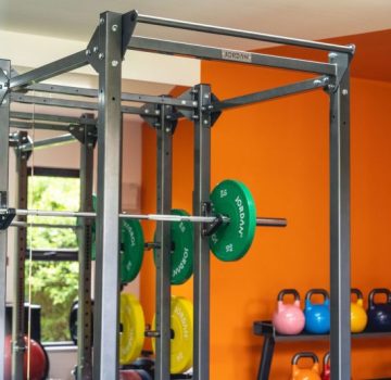 Gym weight lifting equipment with orange wall behind